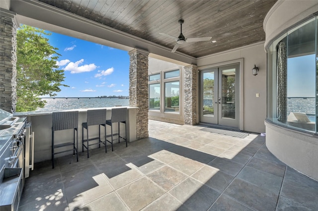 view of patio / terrace with ceiling fan, outdoor wet bar, and french doors