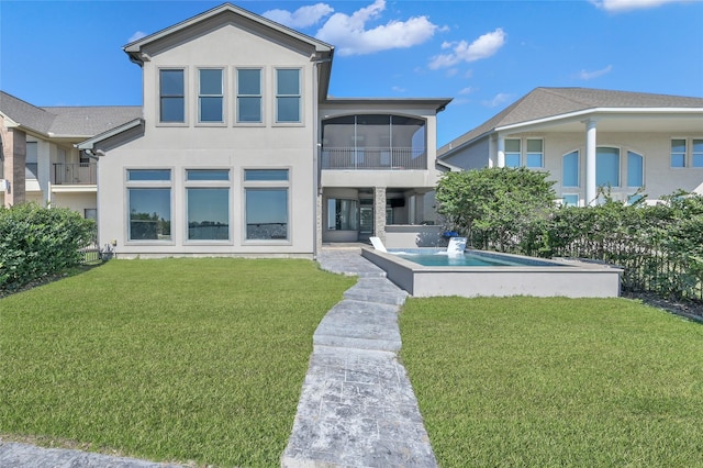 16434 Clear Water Cir, Montgomery, TX 77356 - rear view of house featuring a yard, stucco siding, and a sunroom
