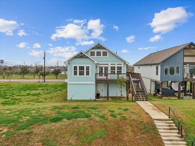 back of house featuring a lawn and a deck