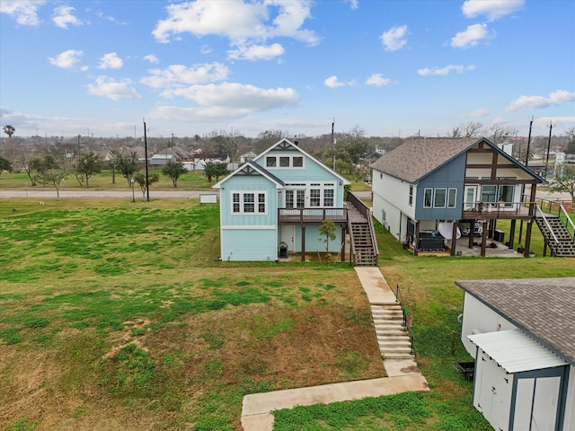 view of front facade featuring a front yard and a deck