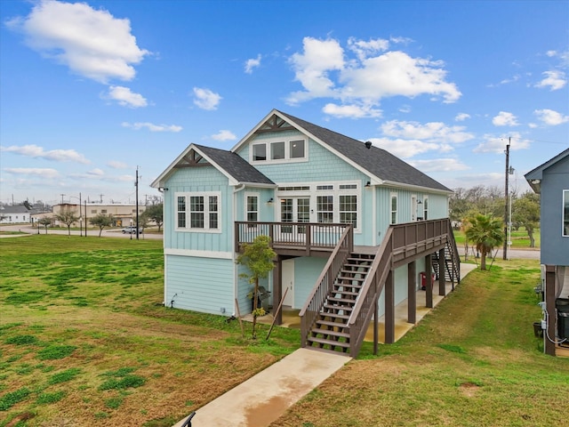 822 W 2nd St, Freeport, TX 77541 - rear view of house featuring stairs, board and batten siding, a deck, and a lawn
