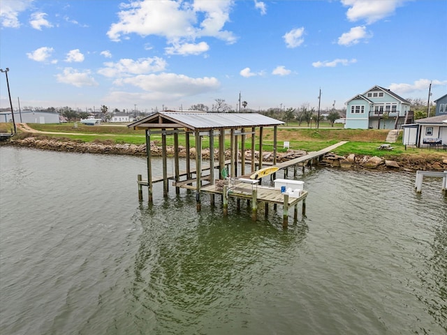 dock area with boat lift and a water view