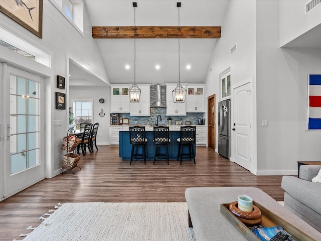 living room with high vaulted ceiling, dark hardwood / wood-style floors, and beamed ceiling