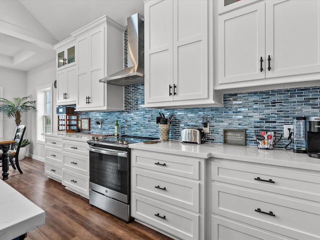 kitchen featuring wall chimney exhaust hood, tasteful backsplash, dark hardwood / wood-style flooring, electric stove, and white cabinets