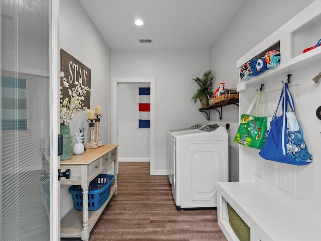 laundry area with dark wood-type flooring and washing machine and clothes dryer