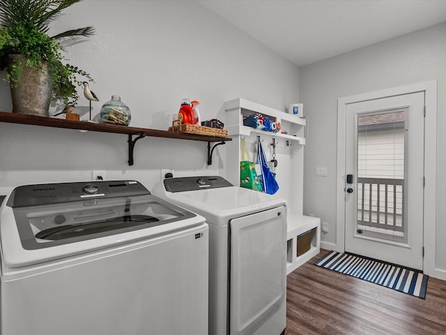 washroom featuring washing machine and clothes dryer and dark hardwood / wood-style flooring