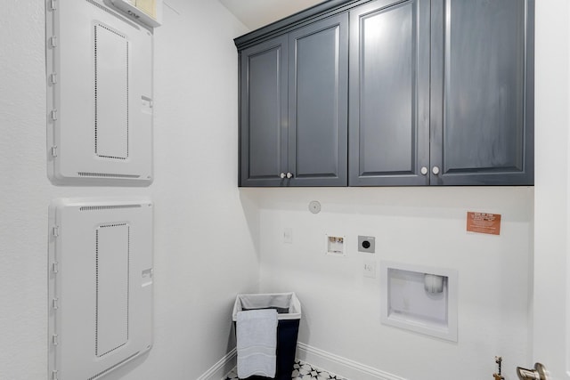 clothes washing area with baseboards, gas dryer hookup, electric panel, and cabinet space