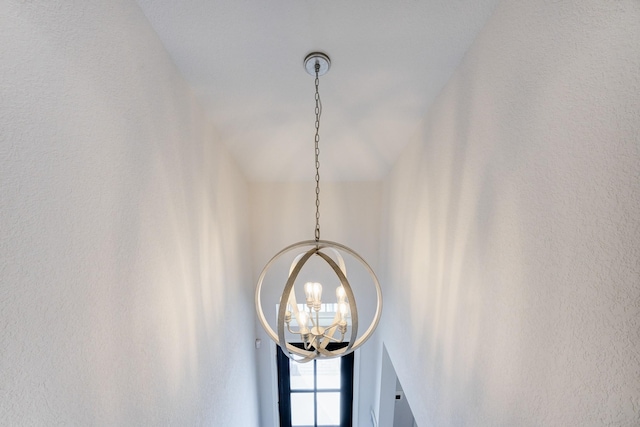 interior details featuring an inviting chandelier