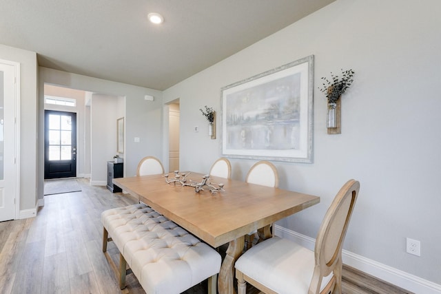 dining space featuring baseboards, light wood-style floors, and recessed lighting
