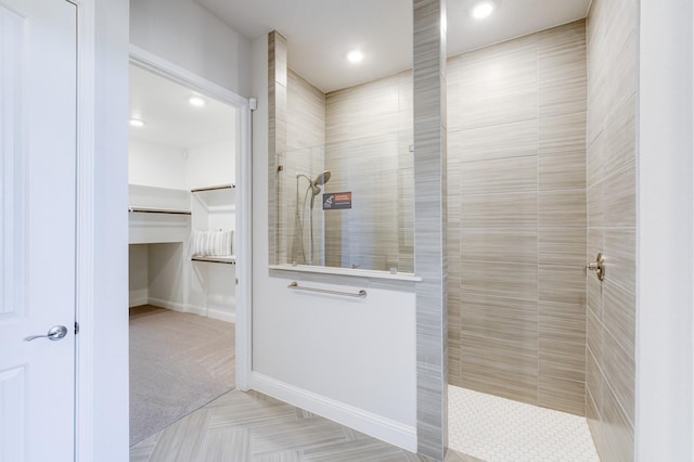 full bath featuring a walk in closet, baseboards, a walk in shower, and recessed lighting