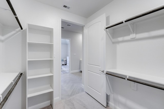 spacious closet featuring visible vents