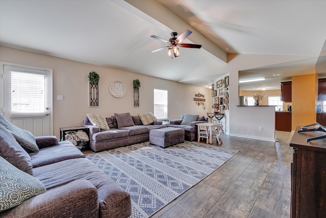 living room with a healthy amount of sunlight, wood-type flooring, and lofted ceiling with beams