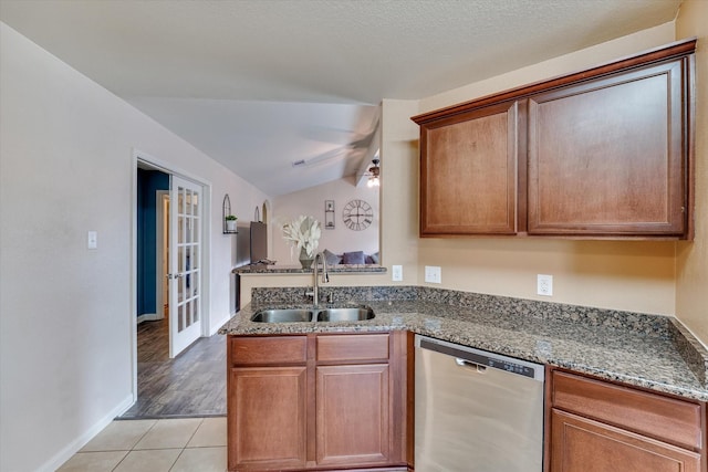 kitchen with light tile patterned flooring, sink, stainless steel dishwasher, ceiling fan, and french doors