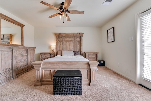 bedroom featuring ceiling fan, light carpet, and multiple windows