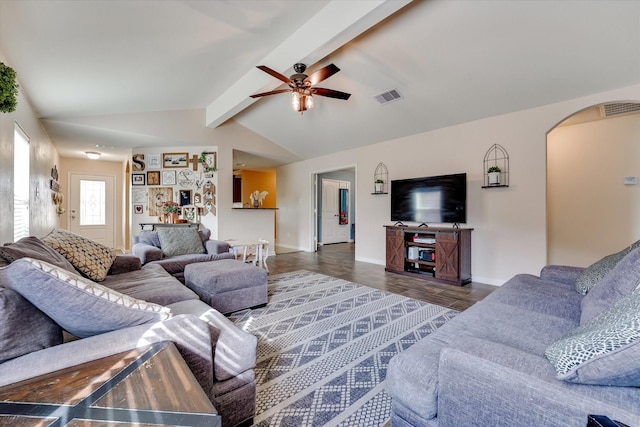 living room with ceiling fan, dark hardwood / wood-style flooring, and vaulted ceiling with beams