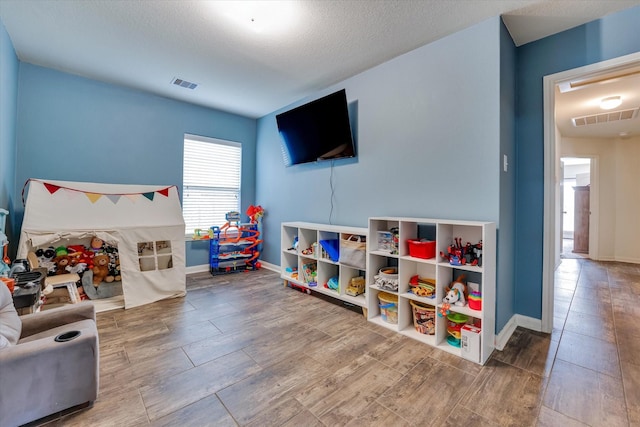 playroom featuring a textured ceiling