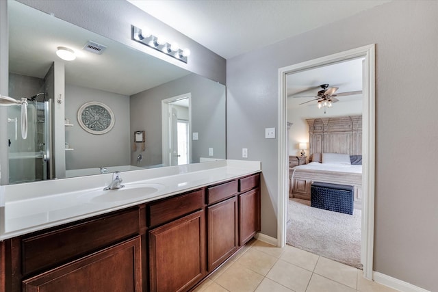 bathroom with vanity, ceiling fan, tile patterned floors, and a shower