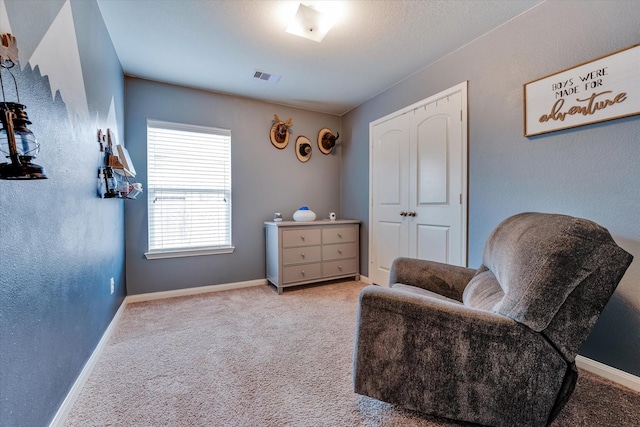 sitting room featuring light carpet