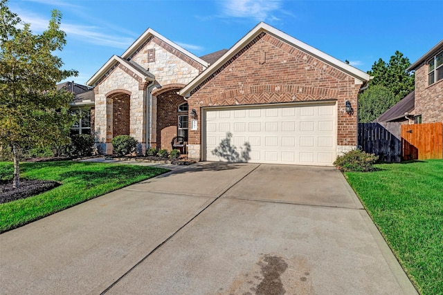 view of front property featuring a garage and a front lawn