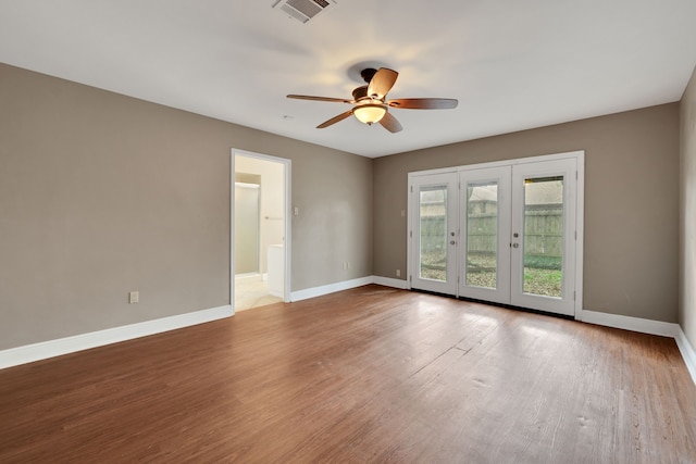 unfurnished room featuring french doors, ceiling fan, and light wood-type flooring