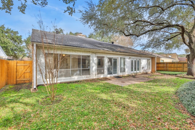 rear view of house with a yard and a patio area