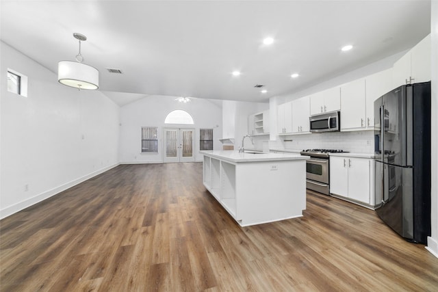 kitchen with stainless steel appliances, hanging light fixtures, sink, and white cabinets