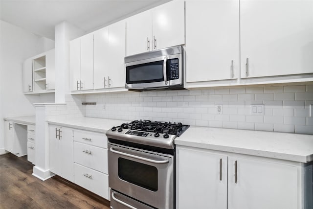 kitchen featuring dark wood-type flooring, tasteful backsplash, stainless steel appliances, light stone countertops, and white cabinets