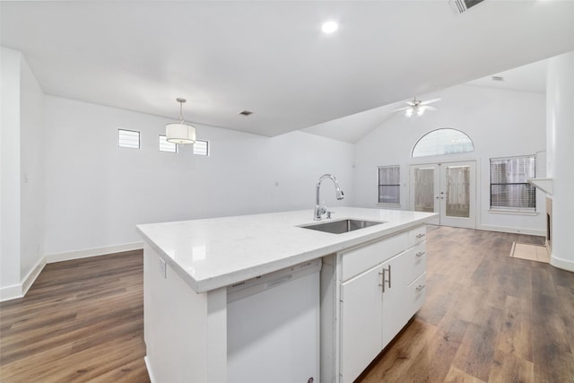 kitchen with sink, dishwasher, a kitchen island with sink, white cabinetry, and decorative light fixtures