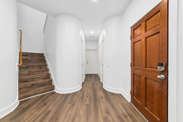 corridor with dark hardwood / wood-style floors