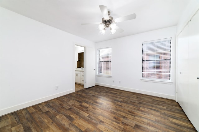 interior space with dark wood-type flooring, ceiling fan, and sink