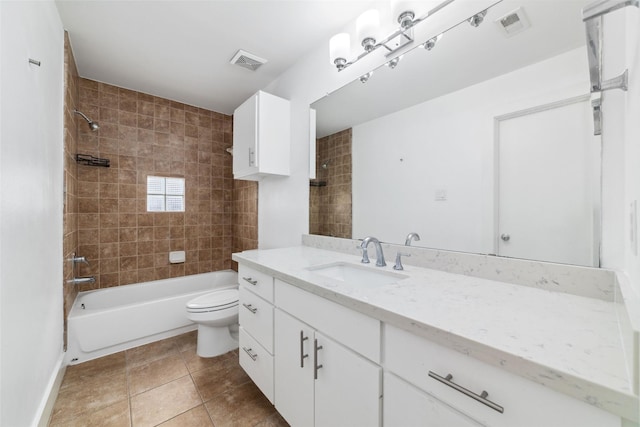 full bathroom with vanity, tiled shower / bath, tile patterned floors, and toilet