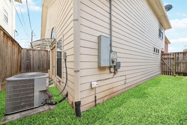 view of home's exterior featuring central AC and a lawn