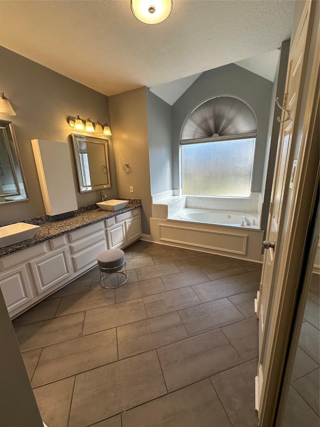 1723 Park Ridge Dr, Katy, TX 77450 - full bath featuring double vanity, a bath, and a textured ceiling
