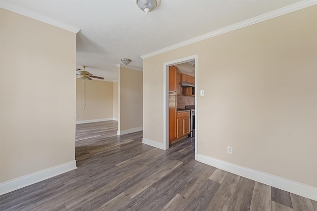 empty room featuring crown molding, dark hardwood / wood-style floors, and ceiling fan