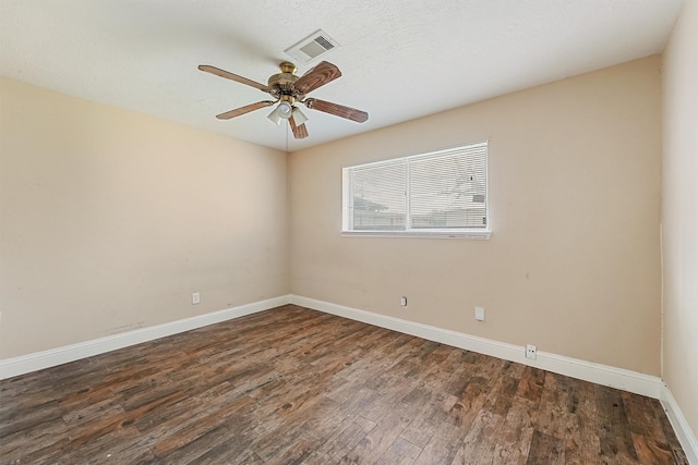 unfurnished room with dark wood-type flooring, ceiling fan, and a textured ceiling