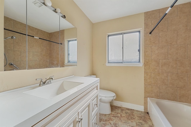 full bathroom with tiled shower / bath combo, vanity, and toilet