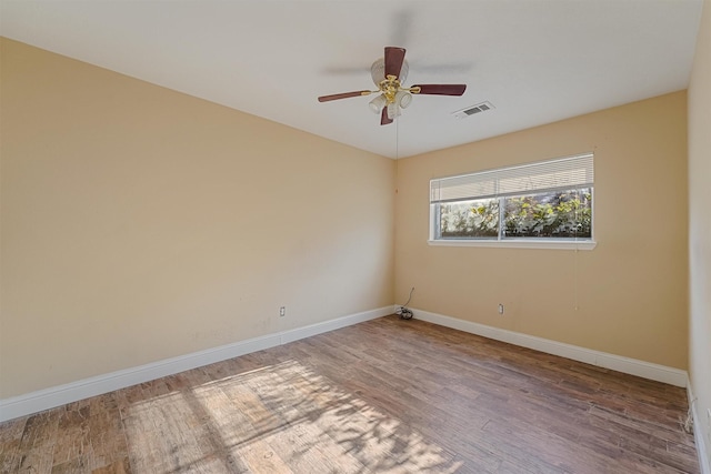 spare room featuring hardwood / wood-style flooring and ceiling fan