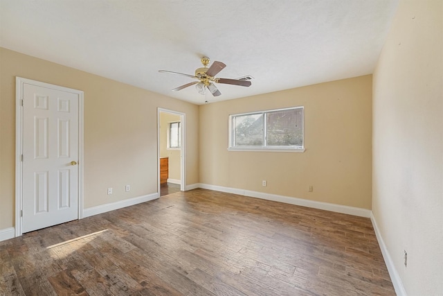 unfurnished room with hardwood / wood-style flooring and ceiling fan