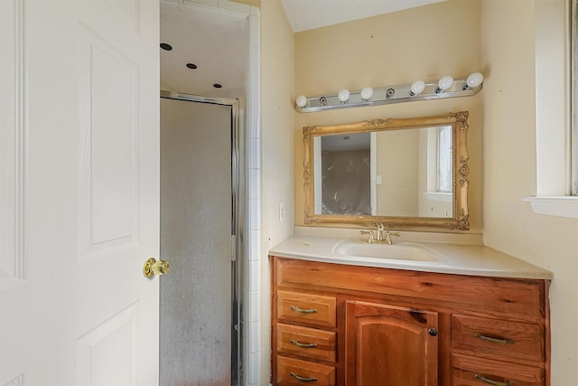 bathroom featuring vanity and a shower with shower door