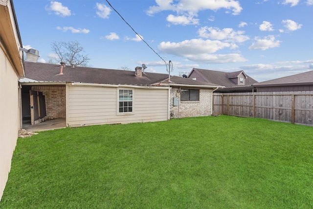 back of house featuring a patio area and a lawn