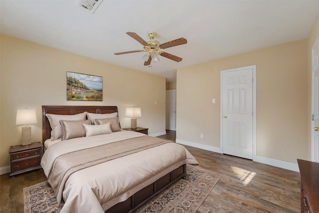 bedroom with ceiling fan and dark hardwood / wood-style flooring