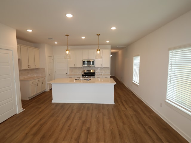 8026 Kay Harbor Dr, Cypress, TX 77433 - kitchen with appliances with stainless steel finishes, backsplash, white cabinets, light countertops, and recessed lighting