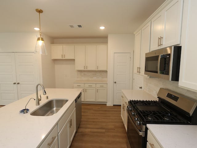 8026 Kay Harbor Dr, Cypress, TX 77433 - kitchen featuring stainless steel appliances, a sink, recessed lighting, white cabinets, and tasteful backsplash