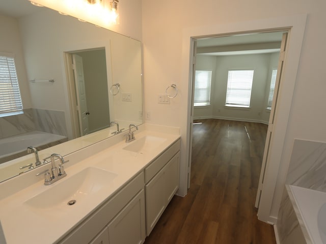 8026 Kay Harbor Dr, Cypress, TX 77433 - full bath featuring a garden tub, double vanity, and wood finished floors
