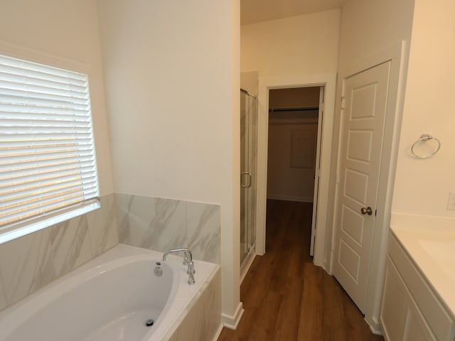 8026 Kay Harbor Dr, Cypress, TX 77433 - bathroom featuring a shower stall, a bath, vanity, and wood finished floors