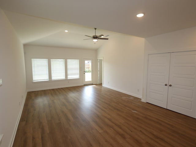 8026 Kay Harbor Dr, Cypress, TX 77433 - unfurnished living room featuring ceiling fan, dark wood finished floors, vaulted ceiling, baseboards, and recessed lighting