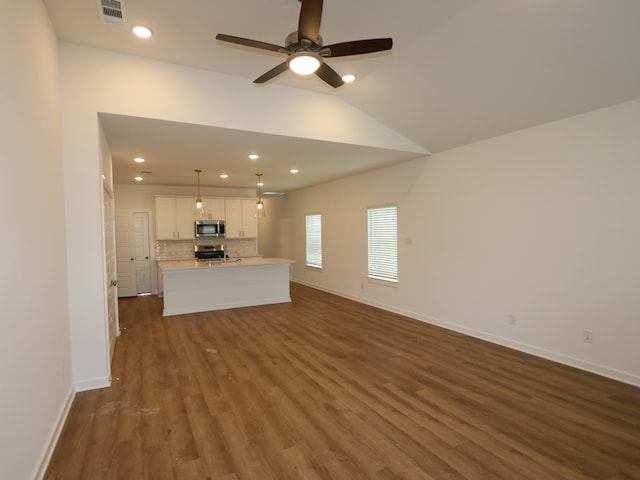 8026 Kay Harbor Dr, Cypress, TX 77433 - unfurnished living room featuring a ceiling fan, dark wood-type flooring, baseboards, recessed lighting, and lofted ceiling