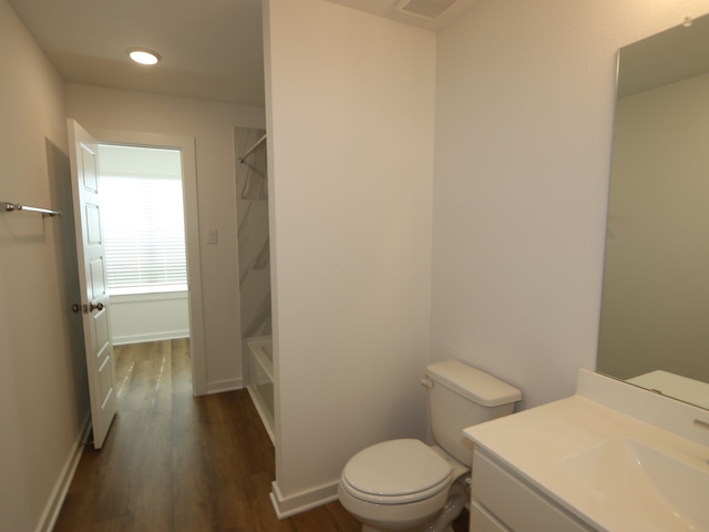8026 Kay Harbor Dr, Cypress, TX 77433 - bathroom with toilet, vanity, wood finished floors, tub / shower combination, and recessed lighting