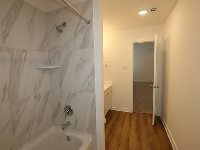 8026 Kay Harbor Dr, Cypress, TX 77433 - bathroom featuring tub / shower combination, wood finished floors, vanity, baseboards, and recessed lighting