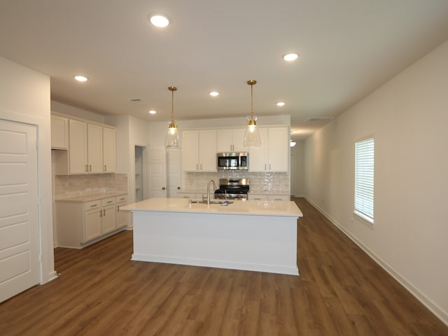 8026 Kay Harbor Dr, Cypress, TX 77433 - kitchen with appliances with stainless steel finishes, white cabinets, decorative backsplash, a sink, and recessed lighting